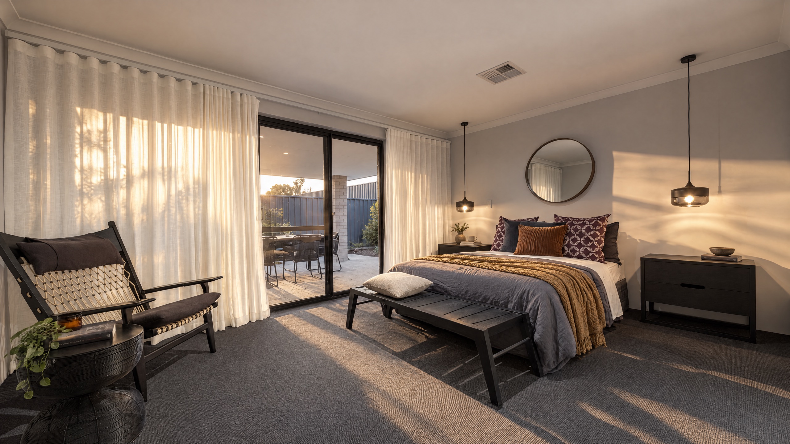 The Bunker Bay bedroom features a king-size bed, a comfortable armchair, and a sliding glass door leading to an outdoor