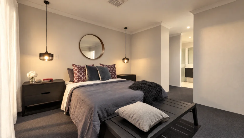 The Karijini bedroom features a king-sized bed with grey linens, dark wood bedside tables, and modern pendant lights.