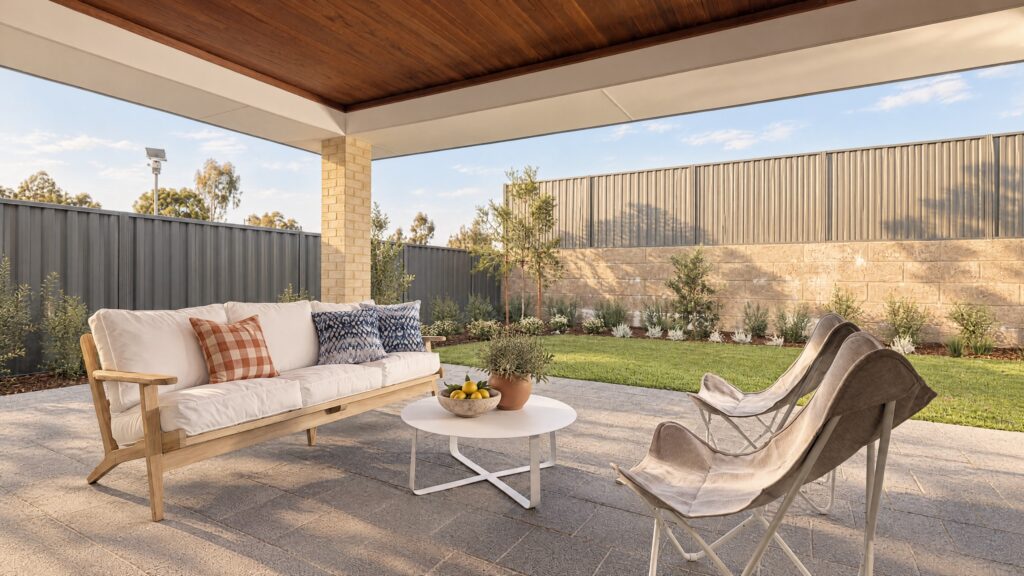 A covered alfresco area with a sofa, coffee table, and chairs overlooking a backyard.