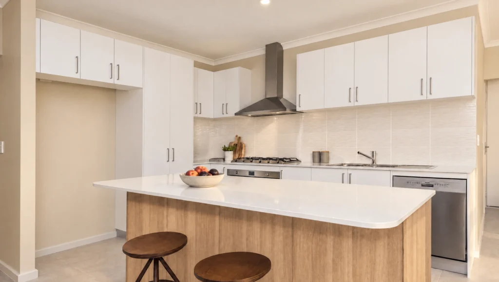 Modern kitchen with white cabinets, a large island with wooden base, and stainless steel appliances.