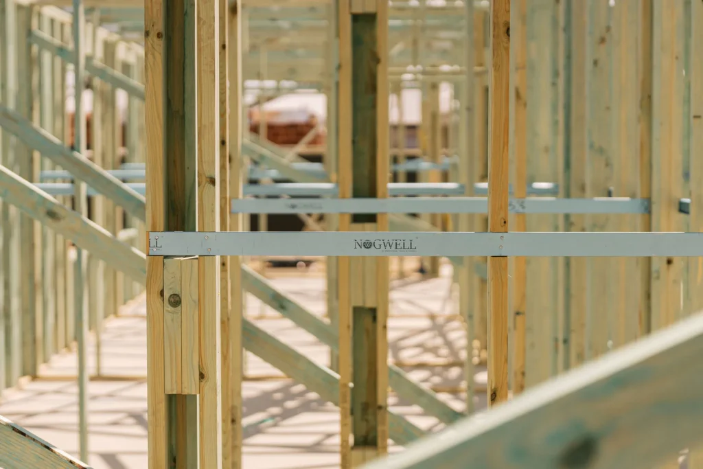 Wooden house frame construction with a Nogwell bracing beam visible.