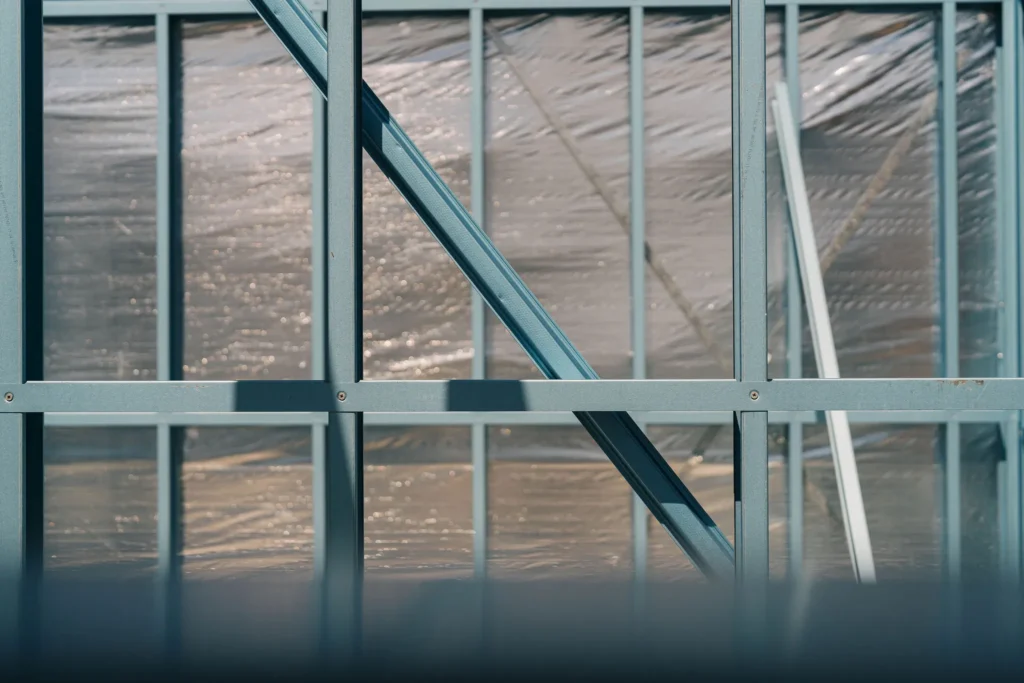 Steel frame construction with reflective insulation material behind it.