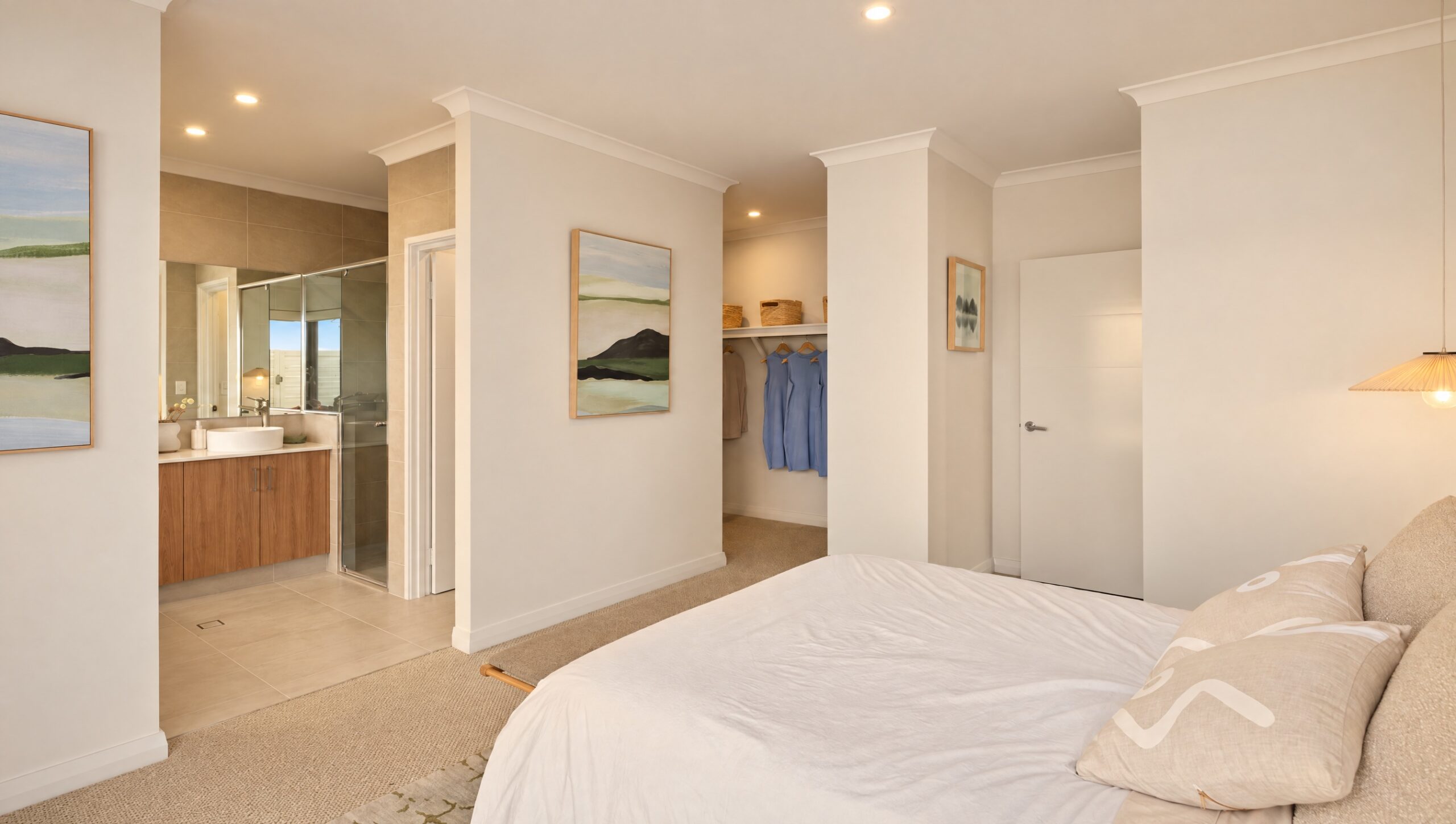 Modern bedroom with ensuite bathroom and walk-in closet featuring blue garments.